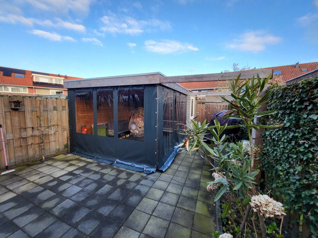 Kleine veranda met planten en zijdoek Kleine veranda met planten en een doek langs de zijkant